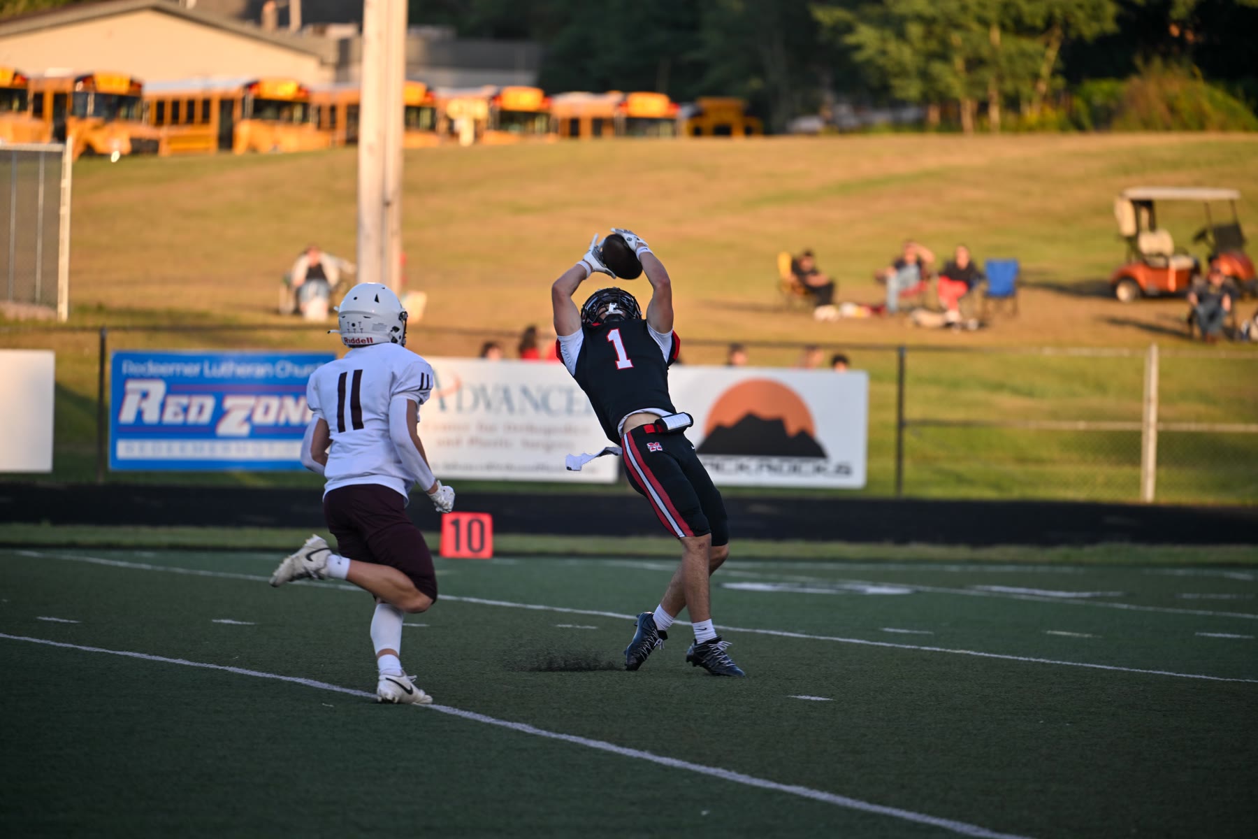 Marquette’s Wesley Robinson pulls in a pass in front of Menominee’s Kiefer Chouinard in the first half. Robinson caught six passes.