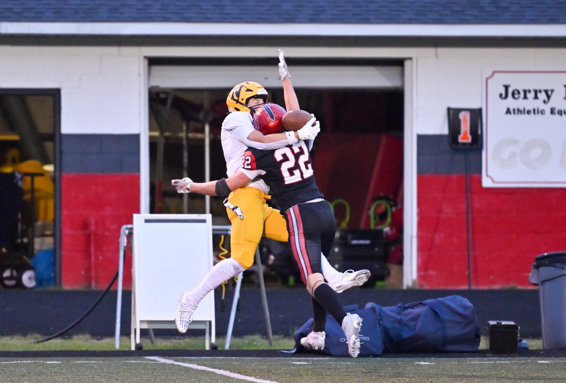 Marquette and Negaunee players go up for the ball along the sideline in the first half.